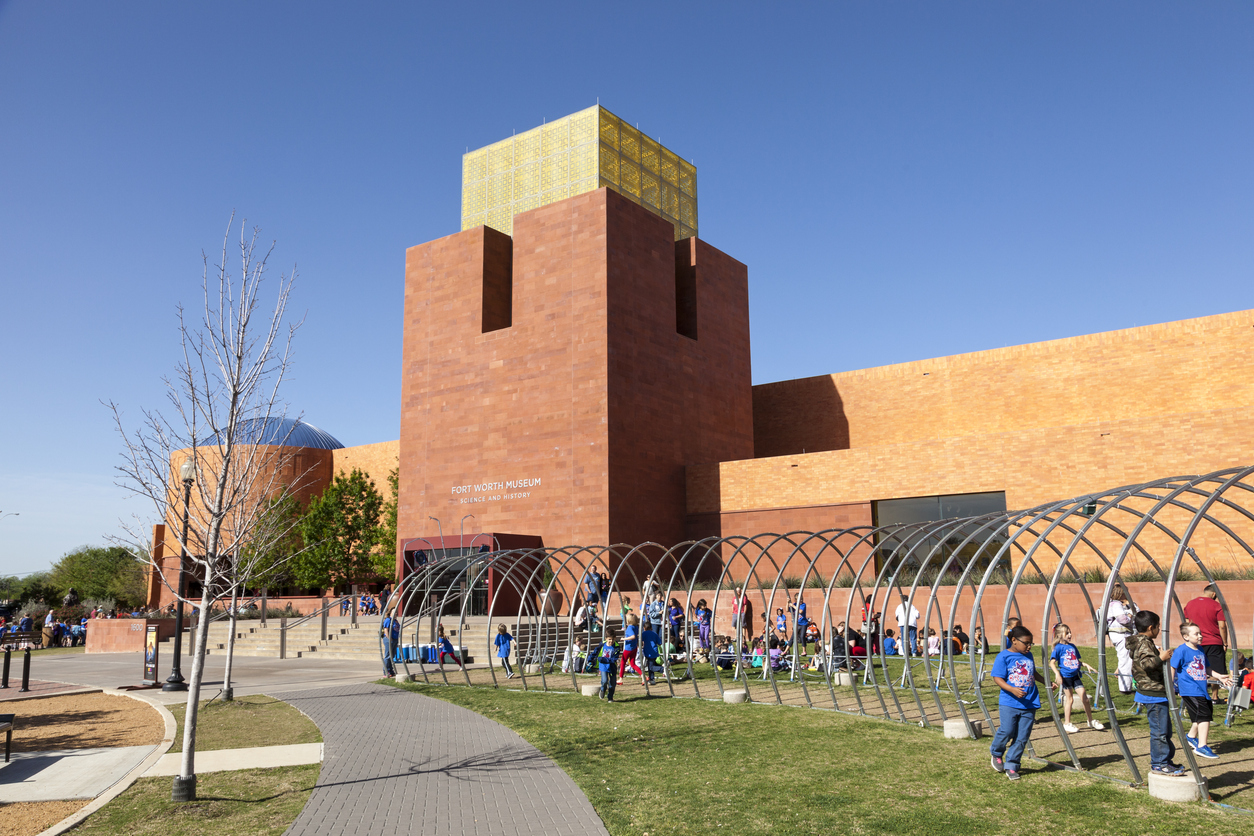 Children playing in front of the Fort Worth Museum of Science and History