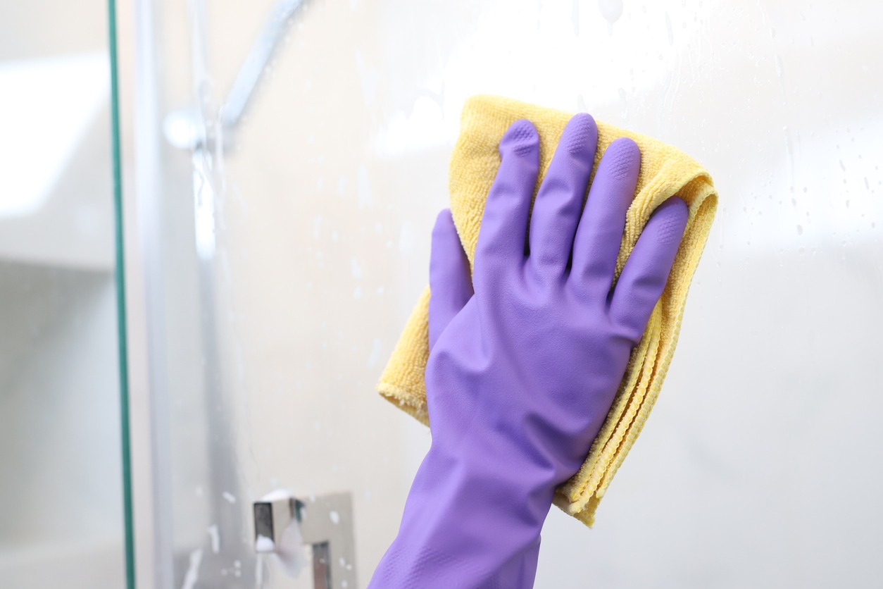 Clean and polish the glass with a rag in the bathroom at home. Cleaning services at home to be hygienic. to prevent bacteria